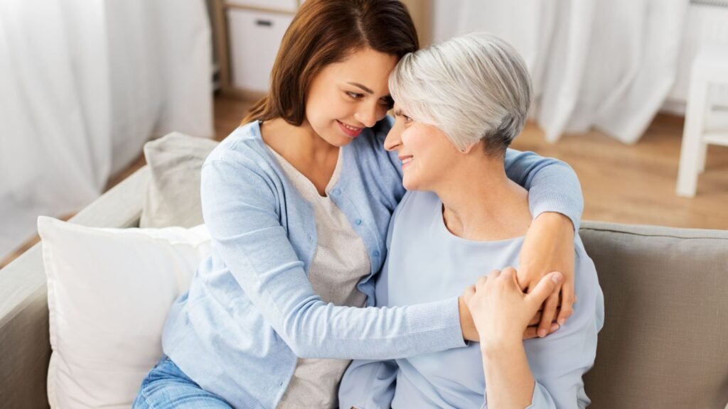 Why Some Adult Children Refuse To Be Their Parents' Retirement Plan Why Some Adult Children Refuse To Be Their Parents' Retirement Plan - Adult daughter and aging mother sitting together on a porch during a bright afternoon, having a thoughtful conversation about family responsibilities and the future.